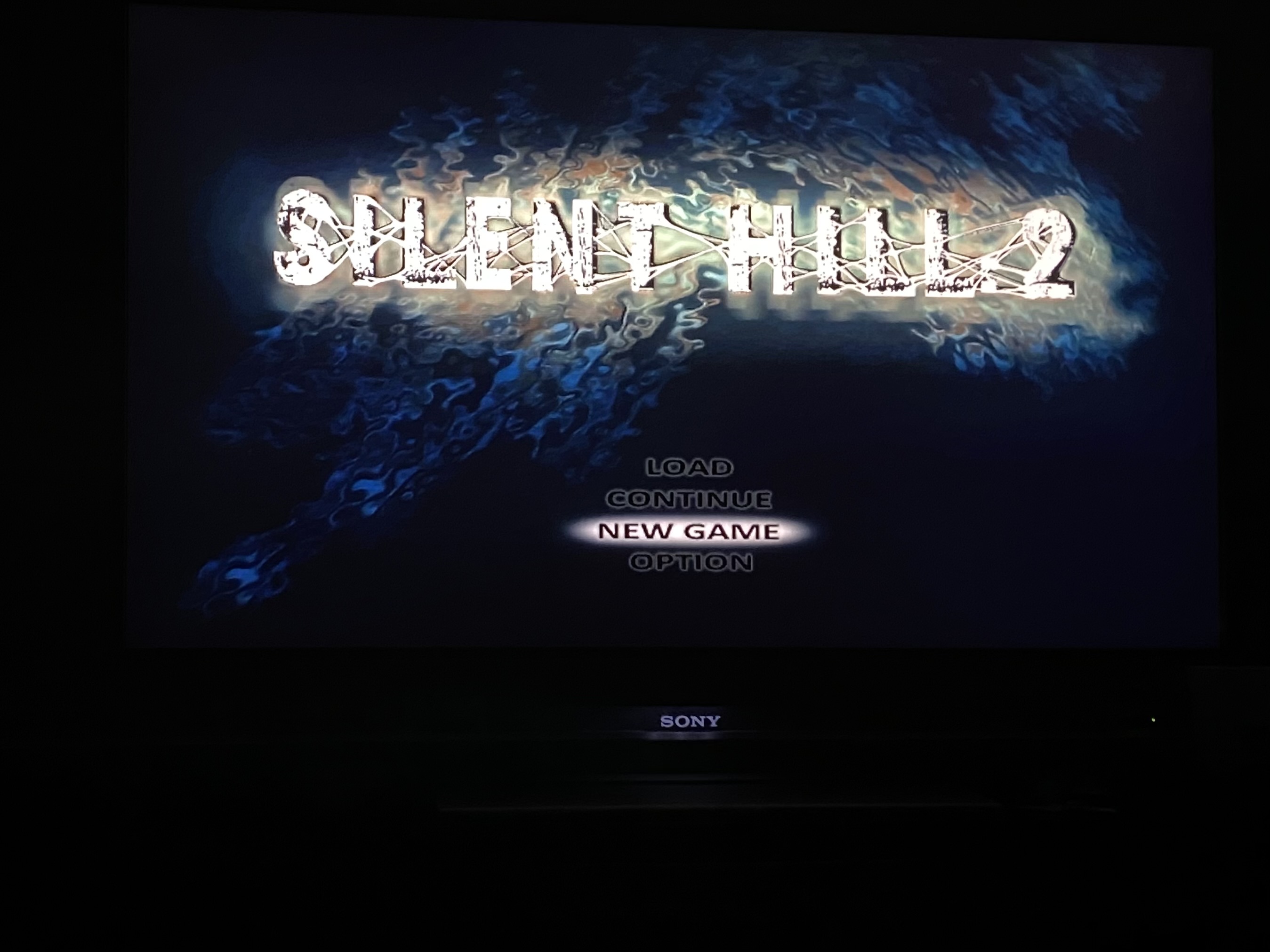 Closeup shot of a televsion with the Silent Hill 2 menu screen showing