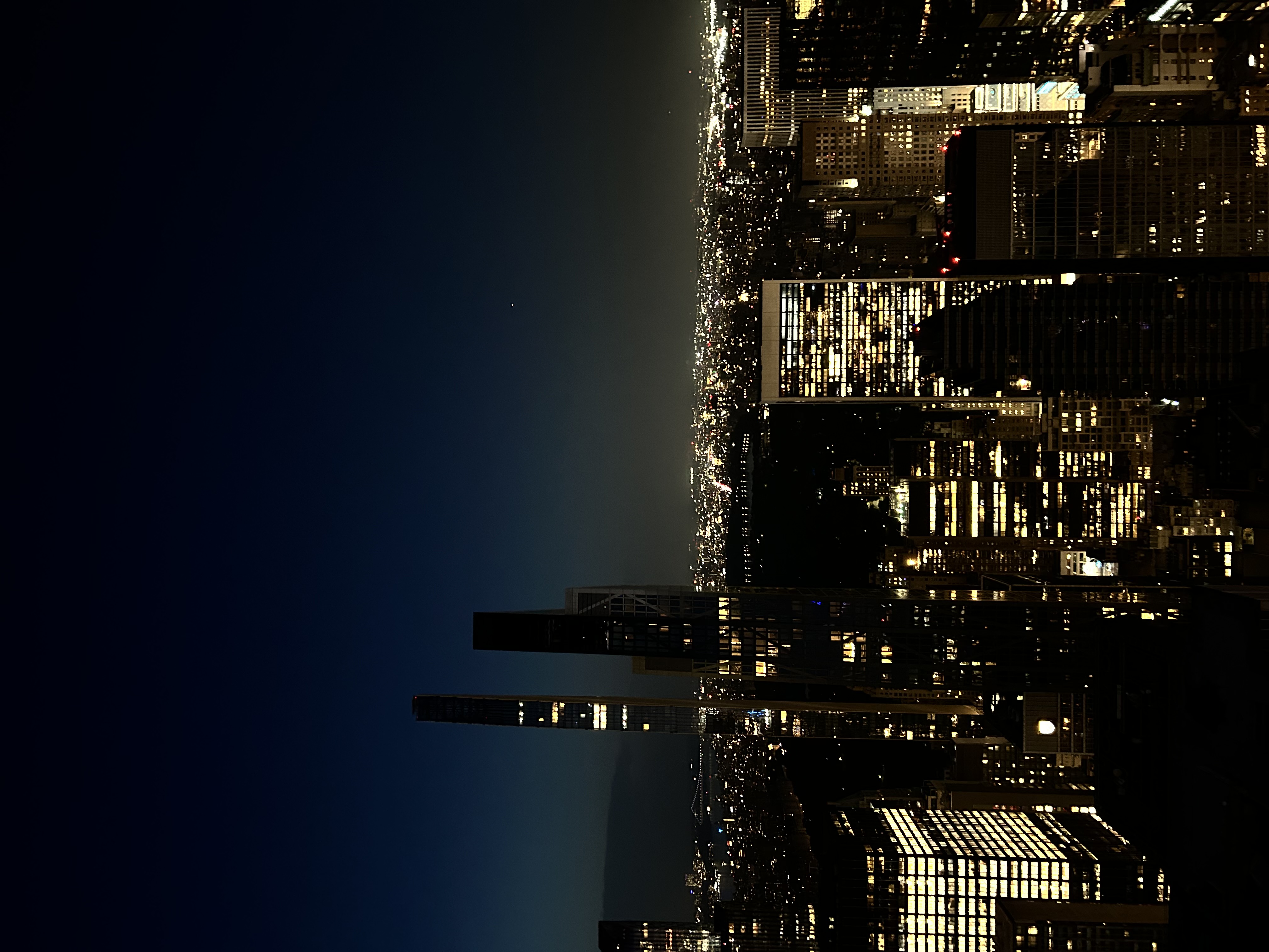 Far off shot of all of New York City at night 